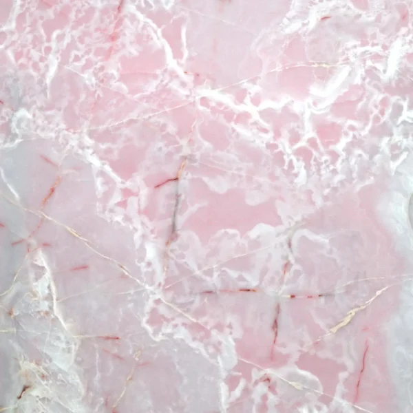 Pink marble surface with white and cream veins, close-up texture central to a countertop or tile finish.