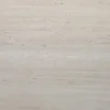 Close-up of a light beige, textured concrete wall with horizontal lines and small holes.